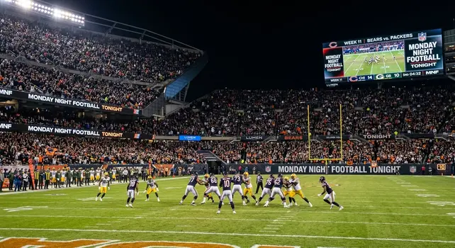 Packed stadium hosting Monday Night Football game between Bears and Packers under floodlights