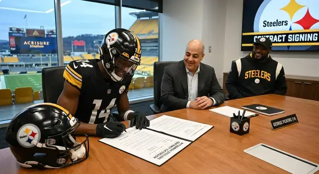 George Pickens signing a contract extension with the Pittsburgh Steelers team executives.